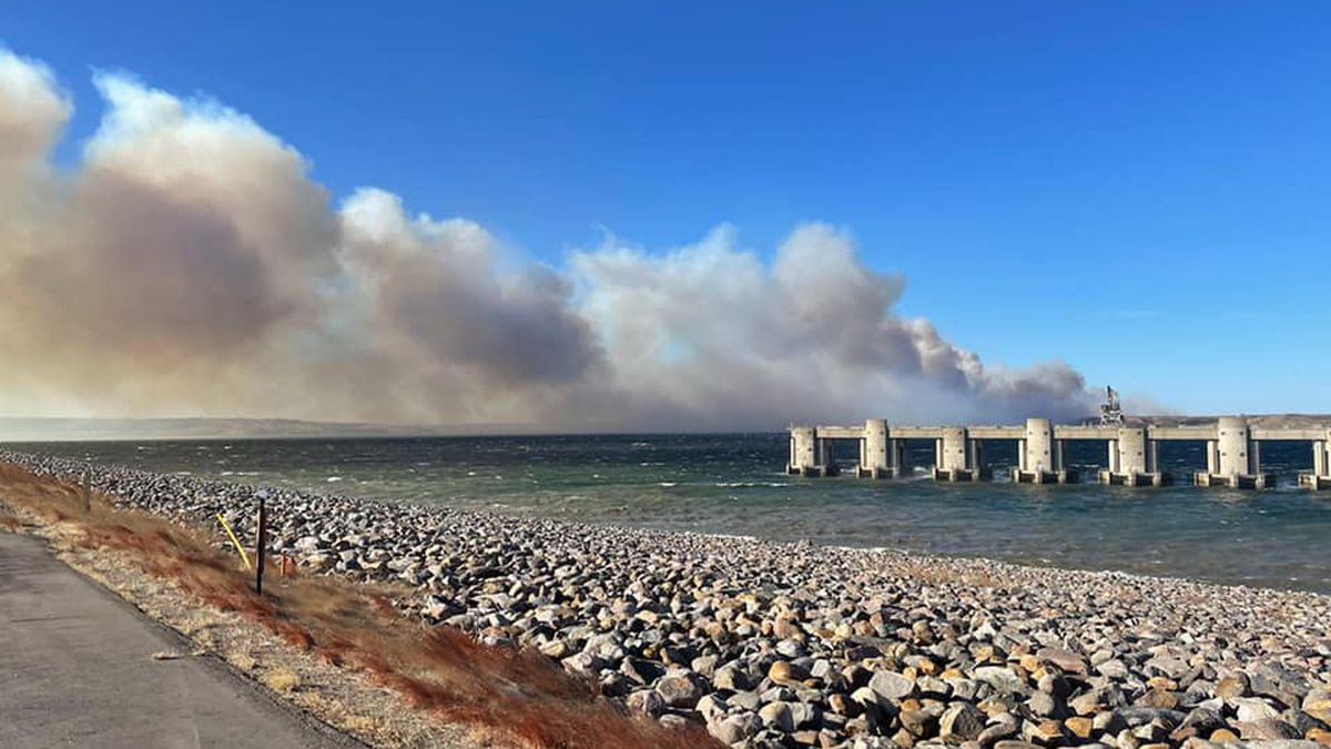 A plume of smoke towers over the Oahe Dam as crews battle a prairie fire on Jan. 14.