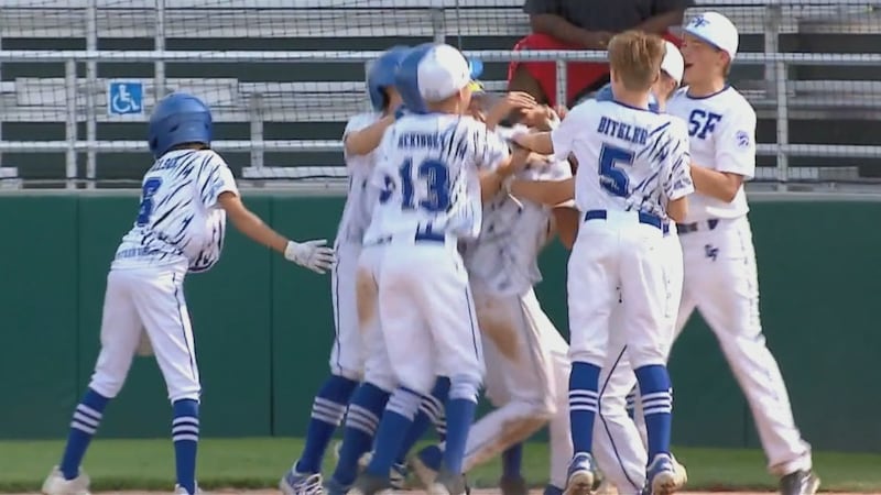 Sioux Falls Little League celebrates with Gavin Weir following his three-run homerun during...