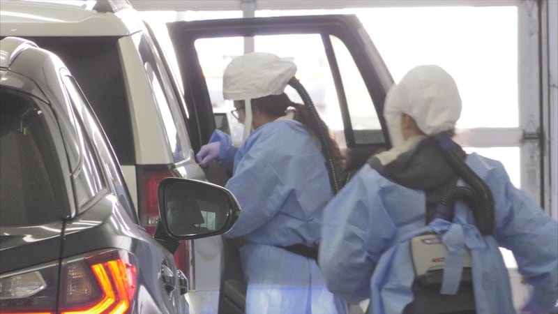 Two Avera employees conduct a drive-thru coronavirus test in Sioux Falls (file)