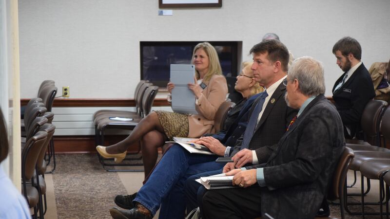 State Rep. Phil Jensen (R-Rapid City) consults with January 6th defendant Treniss Evans about...