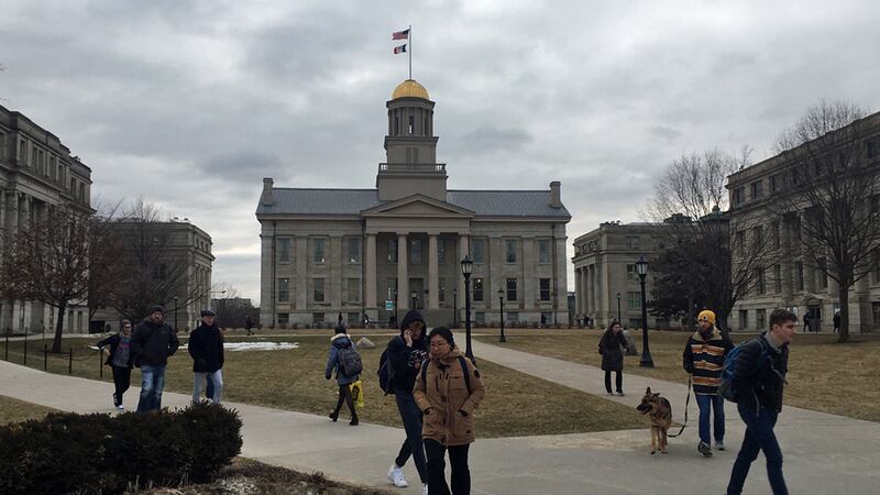 People walk on the Pentacrest on the University of Iowa campus in Iowa City on Tuesday, Feb....