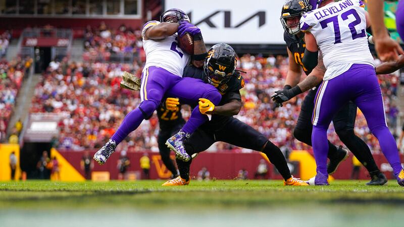 Minnesota Vikings running back Alexander Mattison (2) is tackled by Washington Commanders...