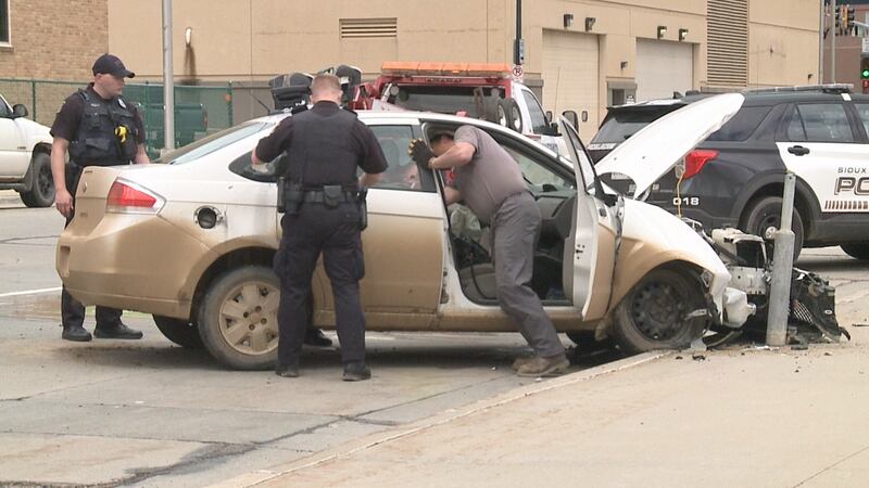 Police arrested a Sioux Falls woman Friday after she tried to strike an officer with her car.